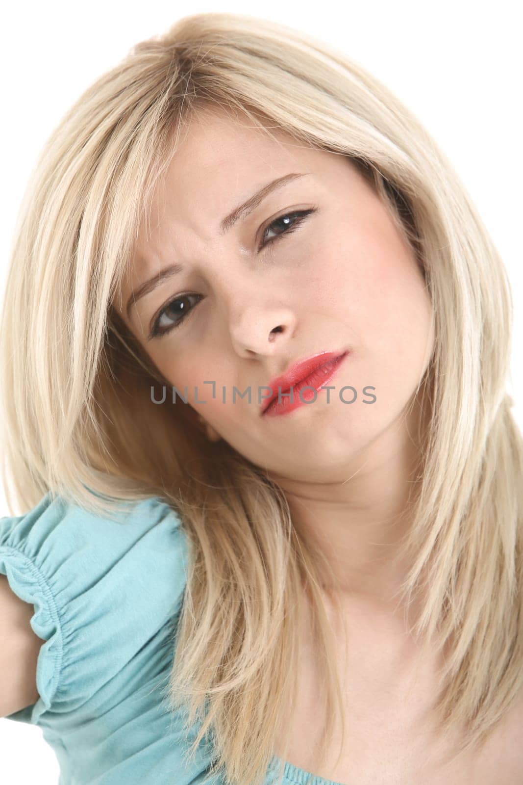 Sad young blond girl looking at the camera.