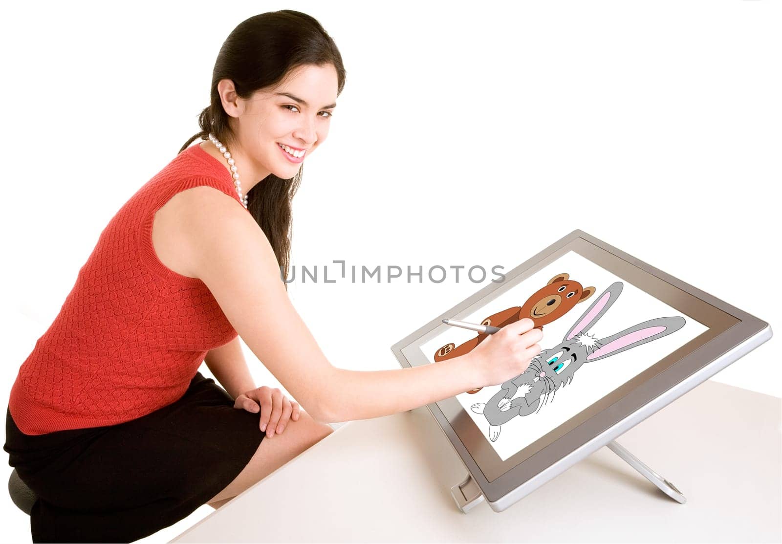 A young woman is drawing on a digital tablet.