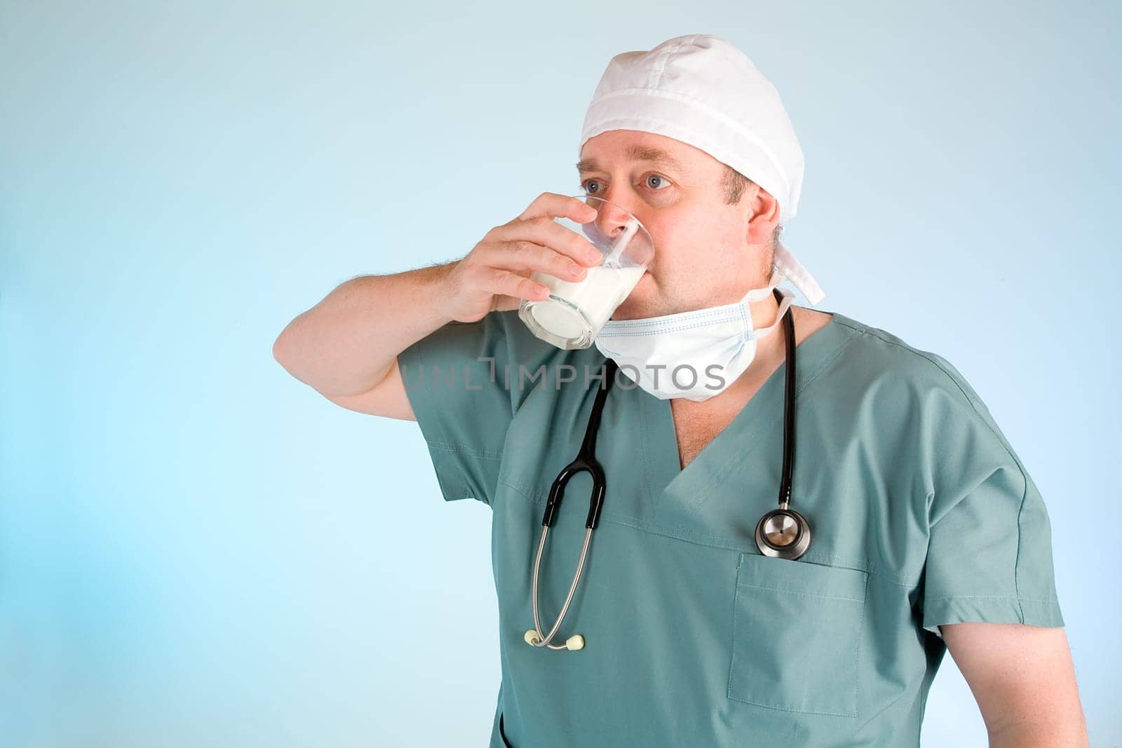 A surgeon or doctor is drinking milk