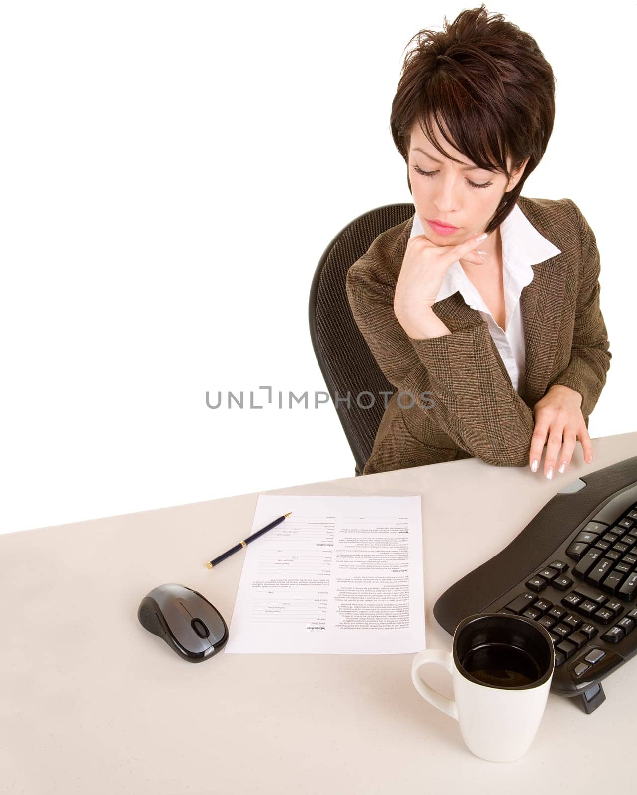 An attractive businesswoman is reading a document.