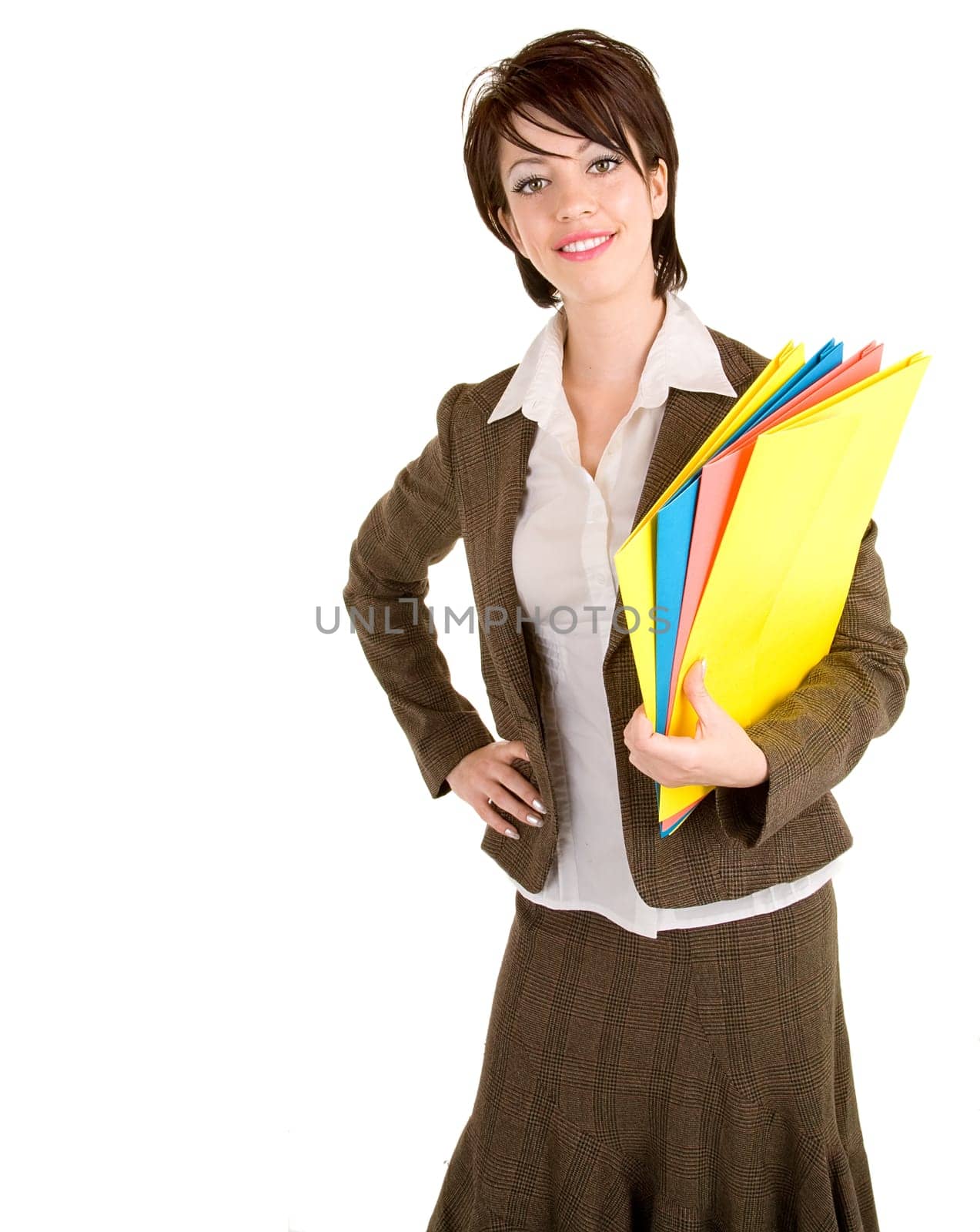 A beautiful smiling businesswoman is carrying colorful business folders.