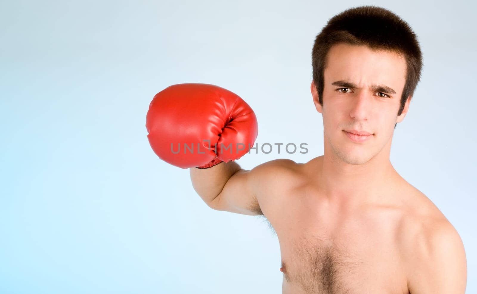 Young boxer ready to punch someone with copy space.