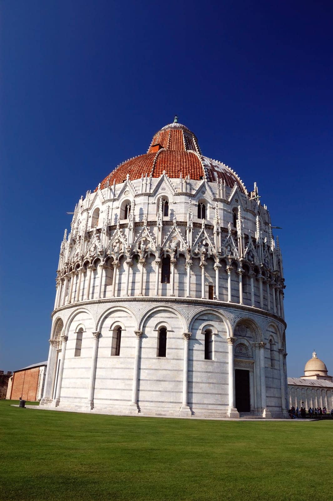 The San Giovanni baptistry in Pisa, Italy, blue sky background
