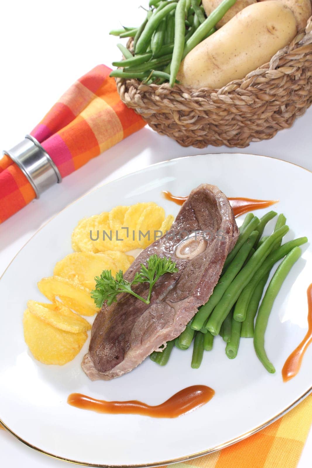 a slice of lamb leg with green beans