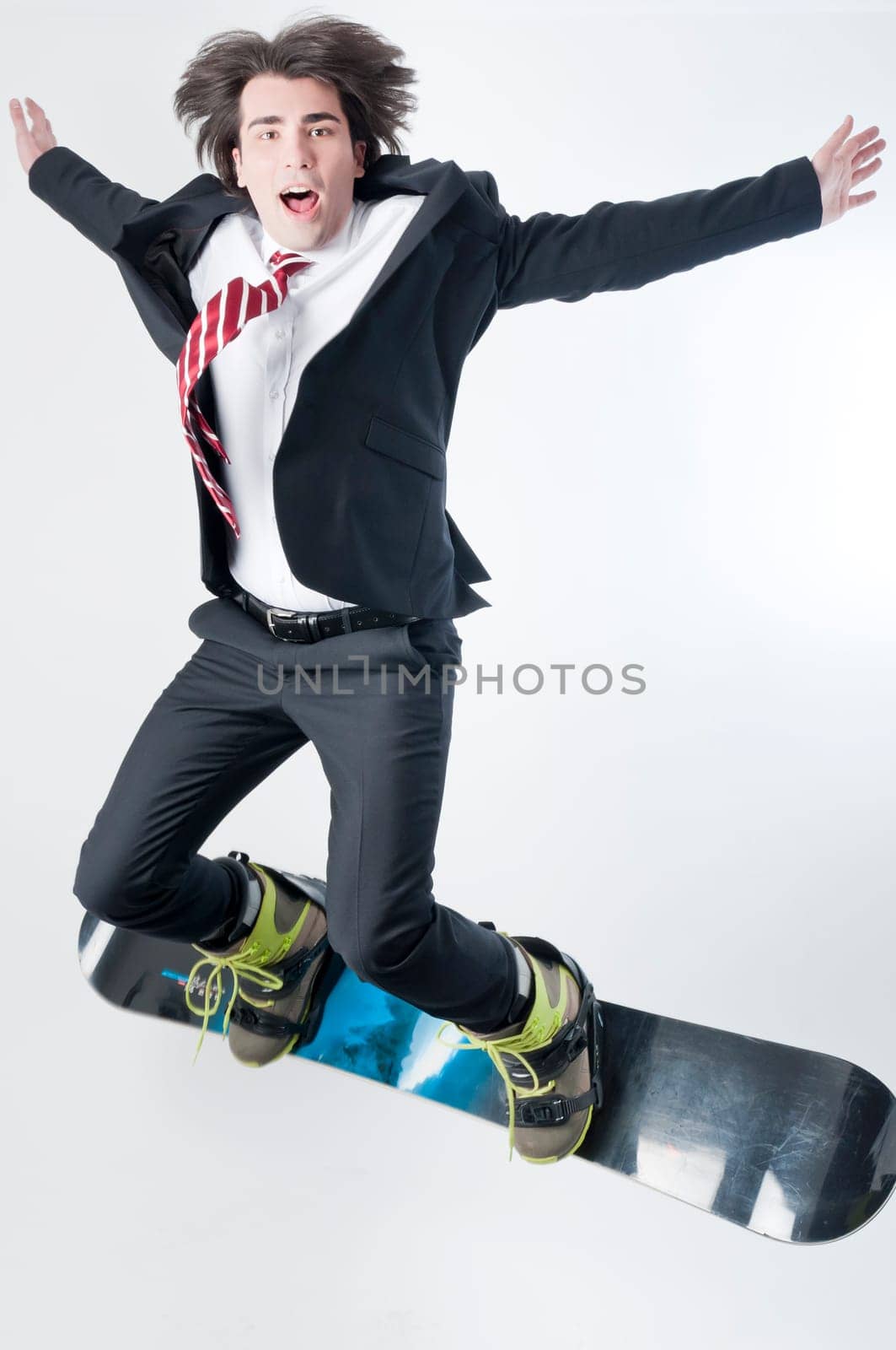 Young business man jumping with a snowboarder