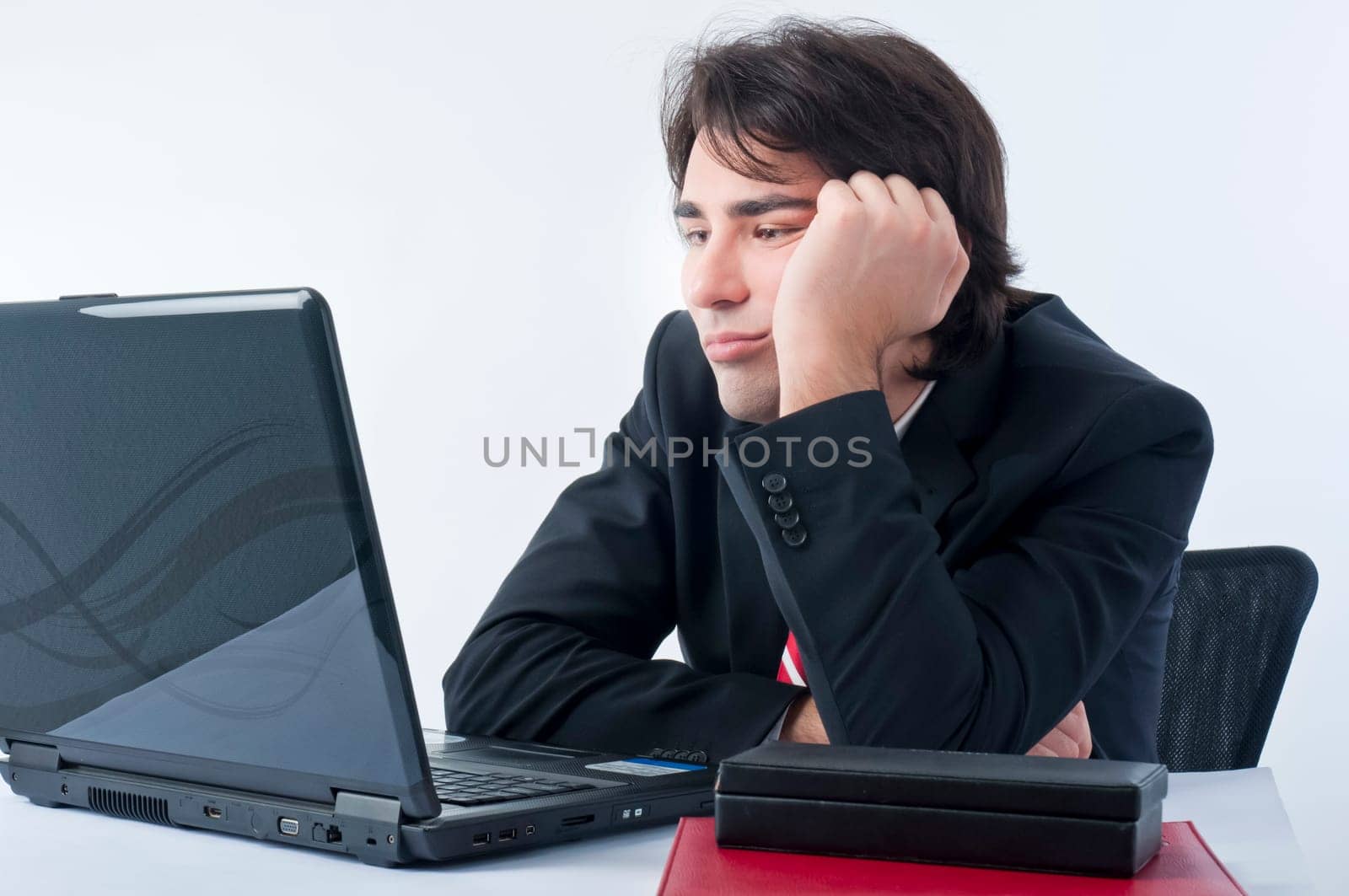 Depressed businessman sitting on his desk
