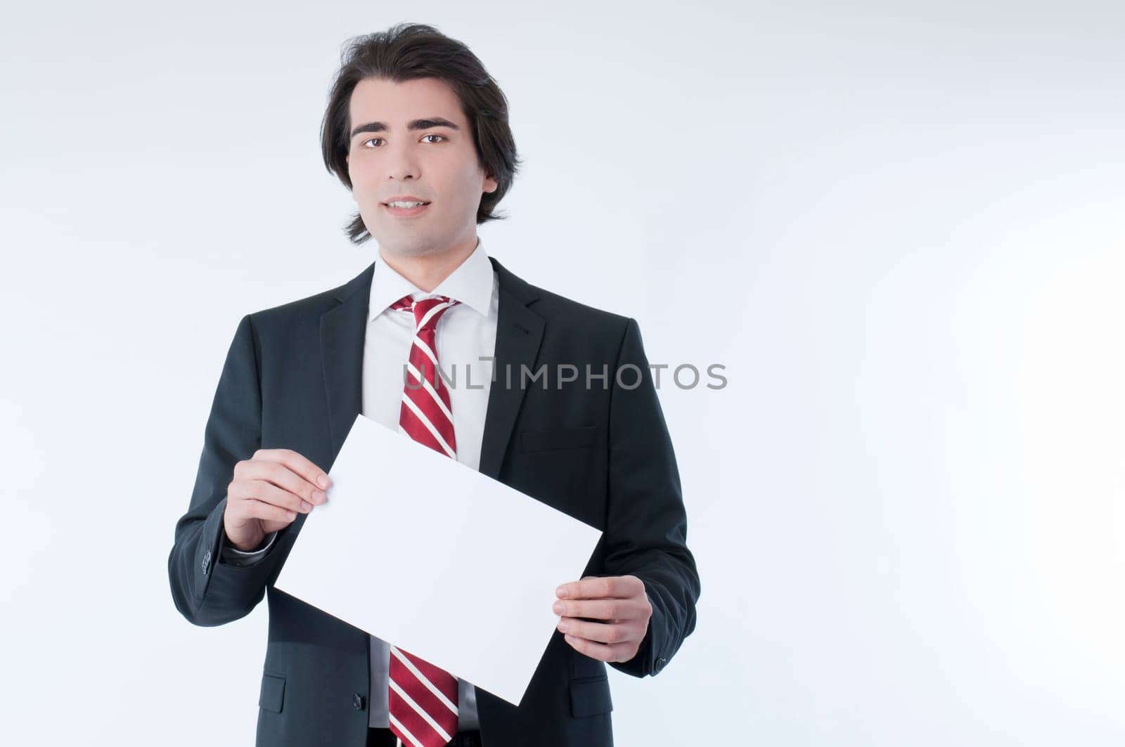 Businessman holding an empty advert in his hands