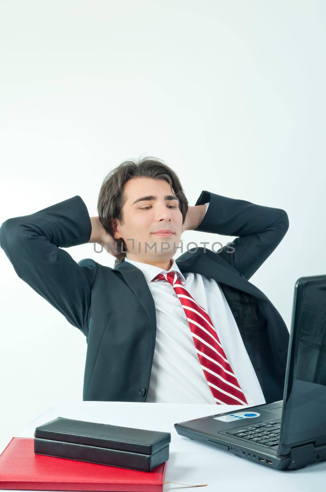Man taking notes from a laptop on a white background
