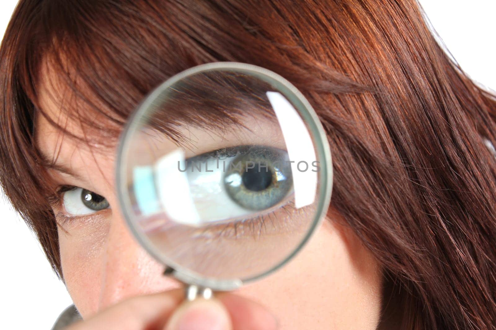 Girl looking for something with a magnifying glass