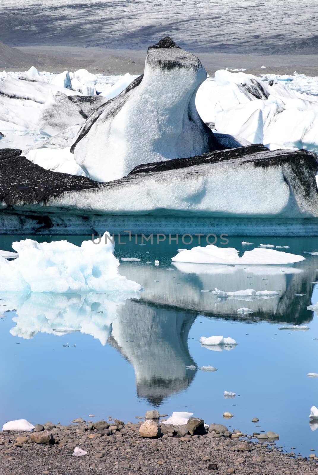 Iceberg reflections on the calm water of the lake Jokulsarlon