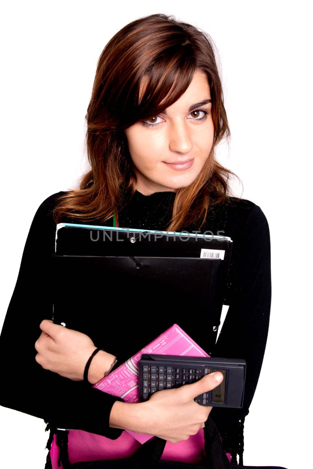 View of a teenager school girl holding books on a white background.