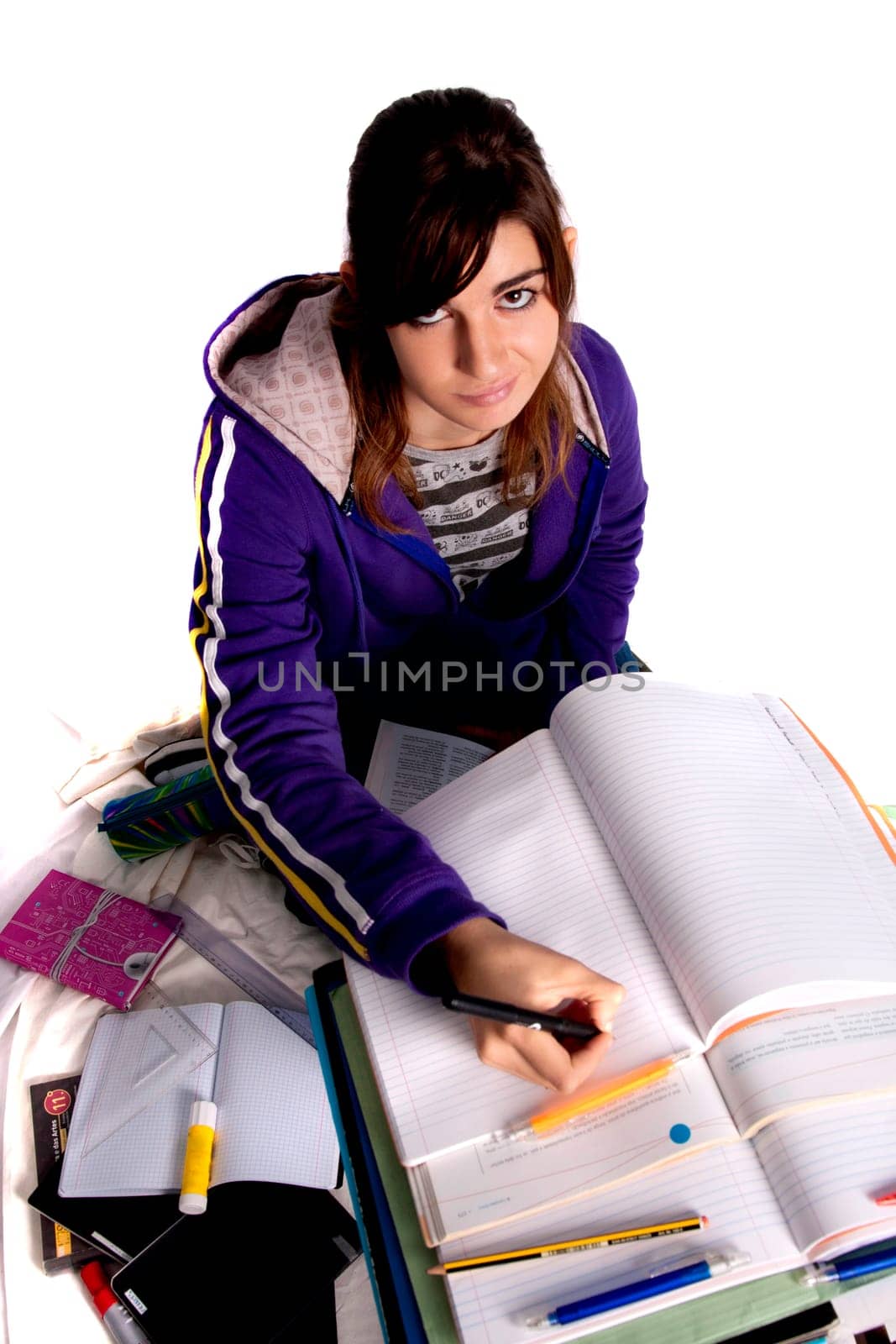 View of a teenager school girl studying on a white background.