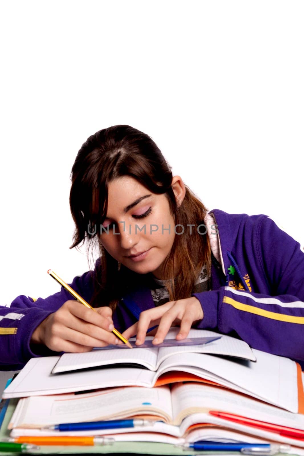 View of a teenager school girl studying on a white background.
