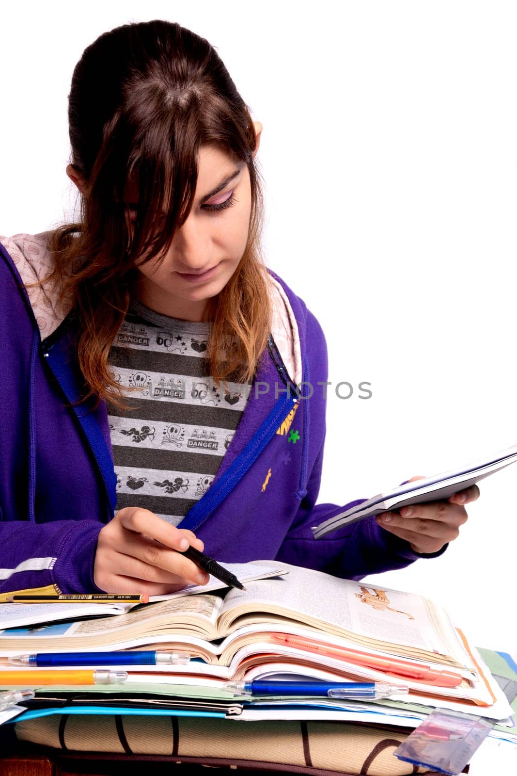 View of a teenager school girl studying on a white background.