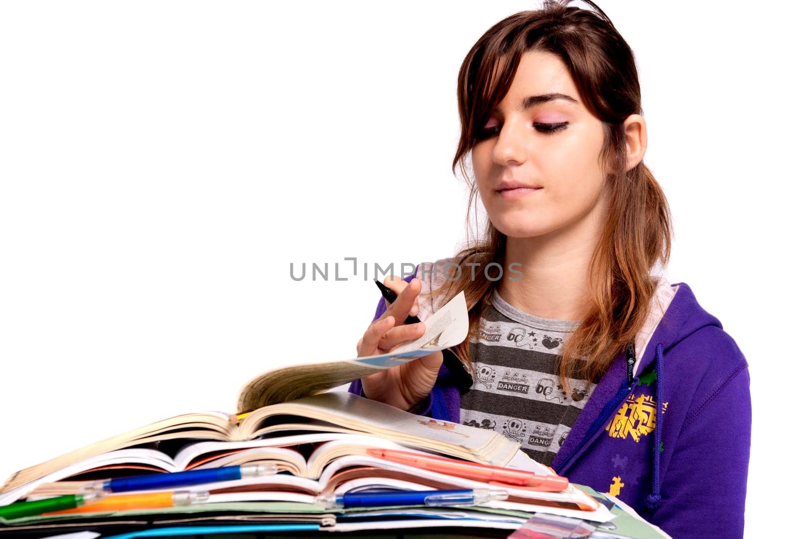 View of a teenager school girl studying on a white background.