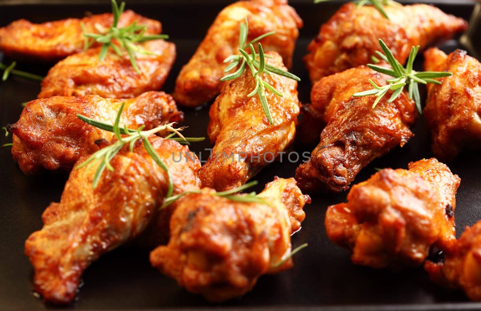 Hot chicken wings on baking tray
