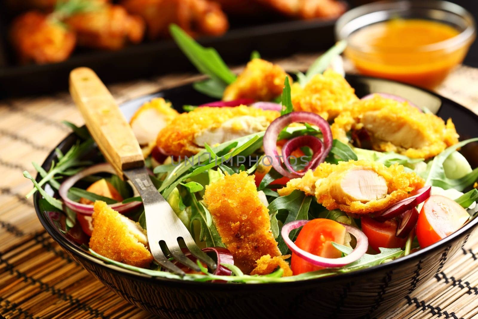 Big gourmet salad with mixed vegetable and curry chicken stripes