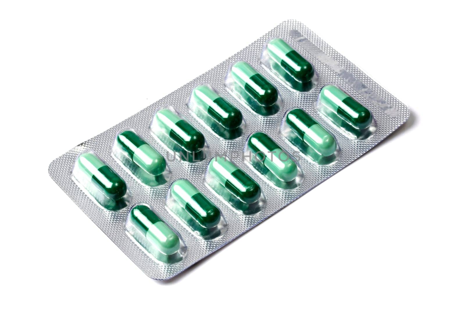Green capsules packed in blister