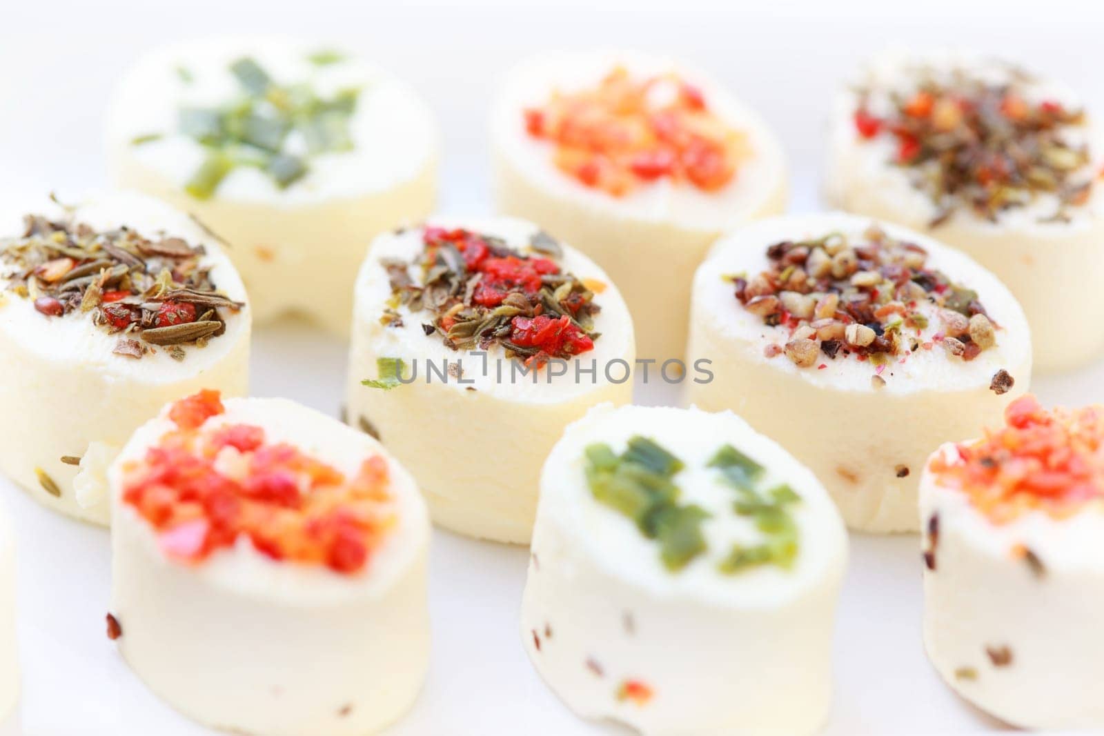 Delicious appetizer - cream cheese with different minced herbs and vegetables