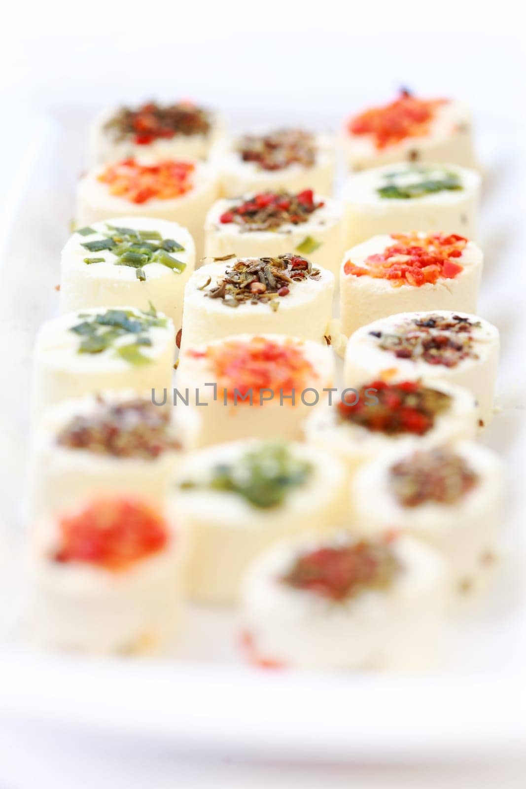 Delicious appetizer - cream cheese with different minced herbs and vegetables