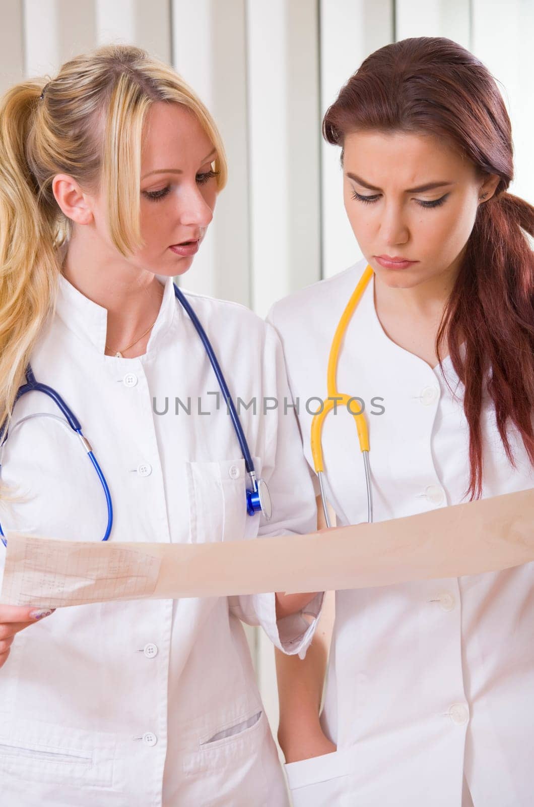 two women doctors reading electrocardiogram