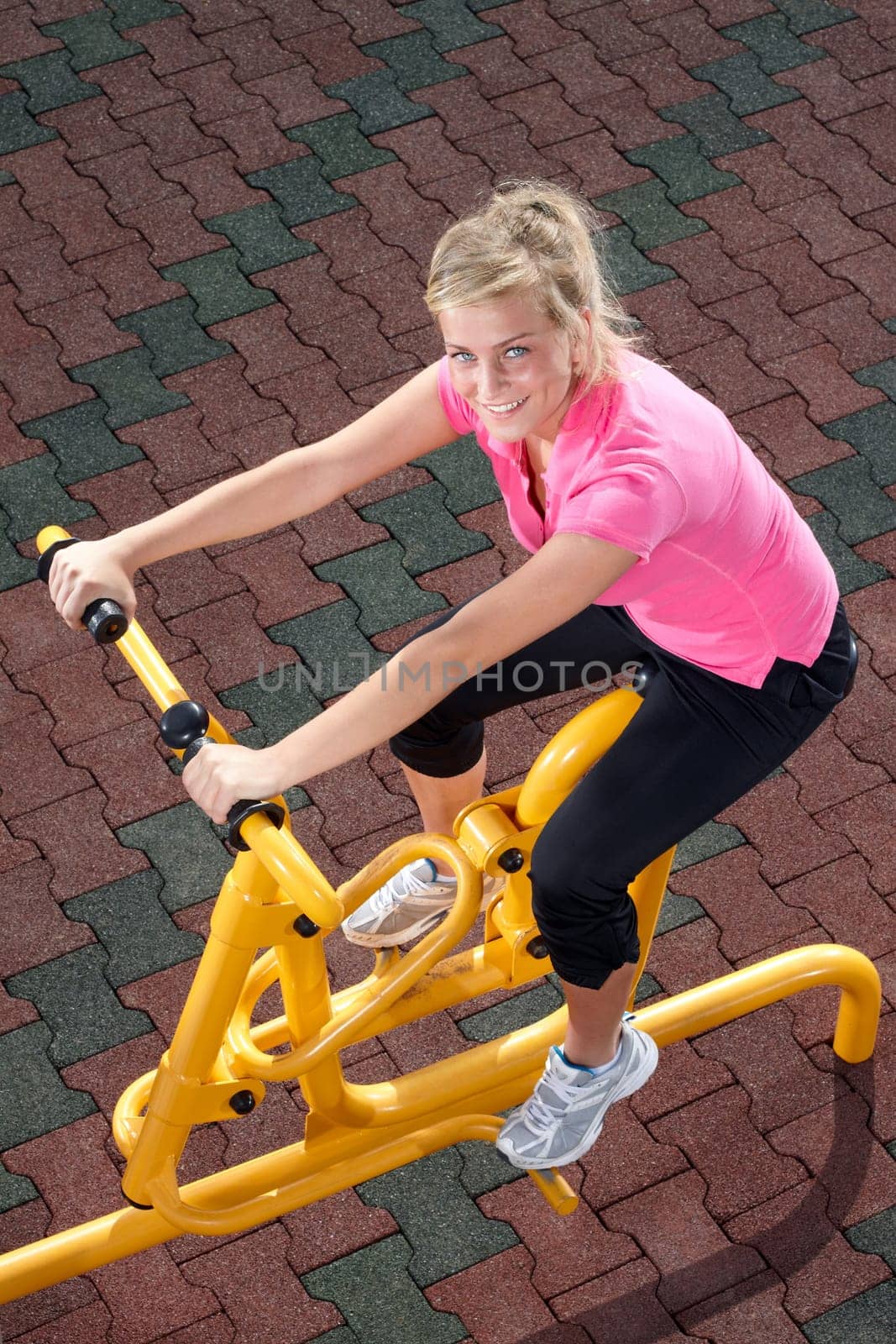 Girl exercising on stepper machine - looking happy