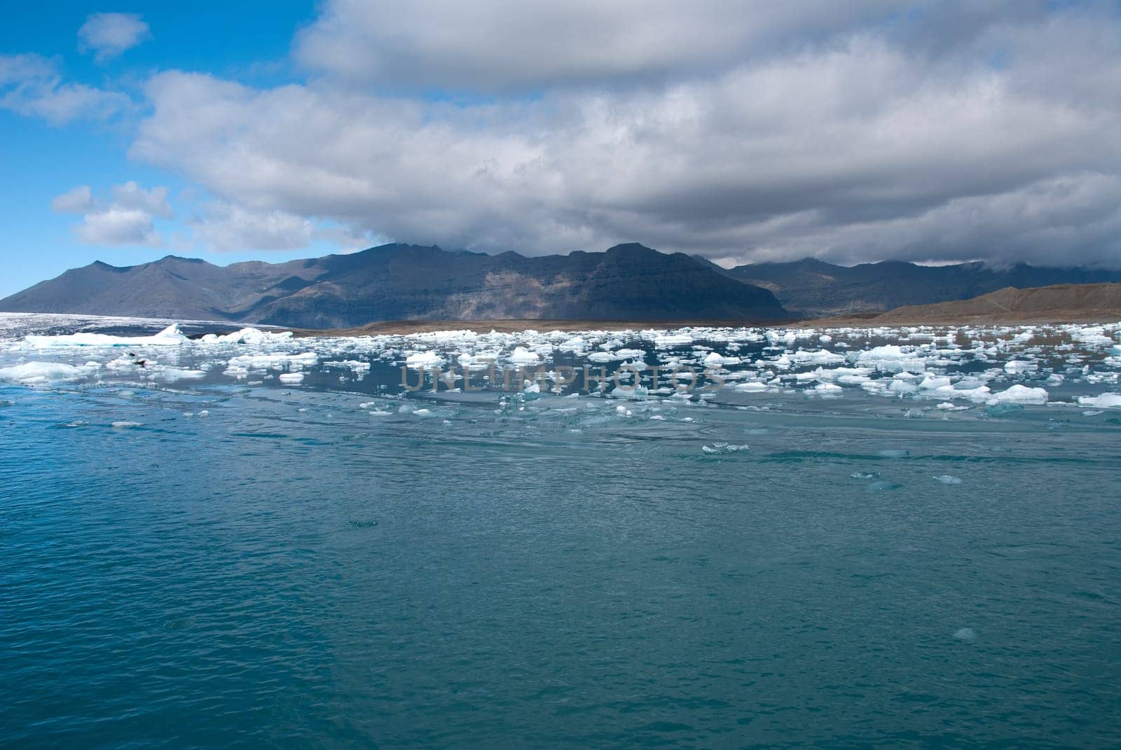 mountains and icebergs on the lake in Iceland Jokulsarlon