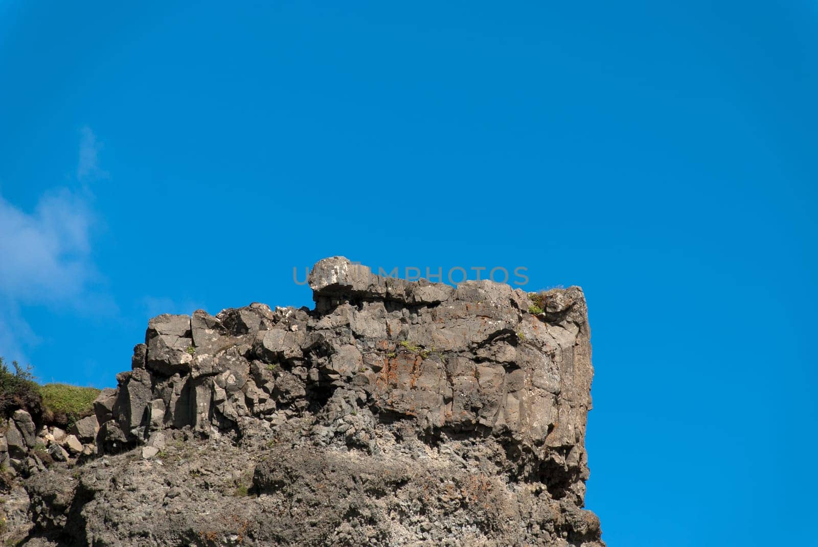 outcrop of rock with blue sky gullfoss in iceland
