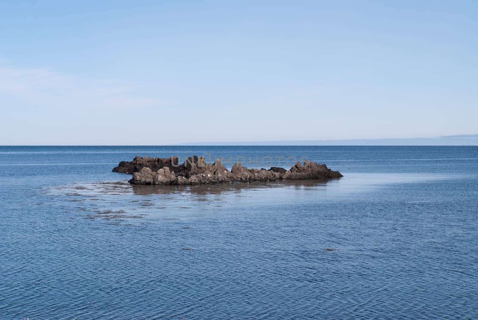 rock in the sea on the peninsula in iceland vatnsness