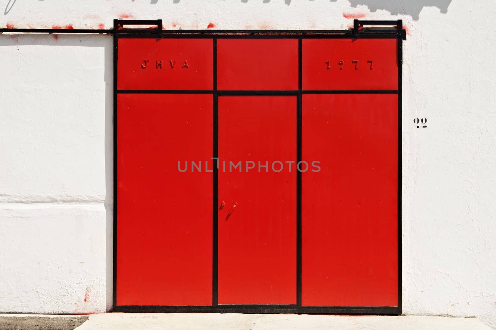 Red sliding gate in a warehouse, Portugal