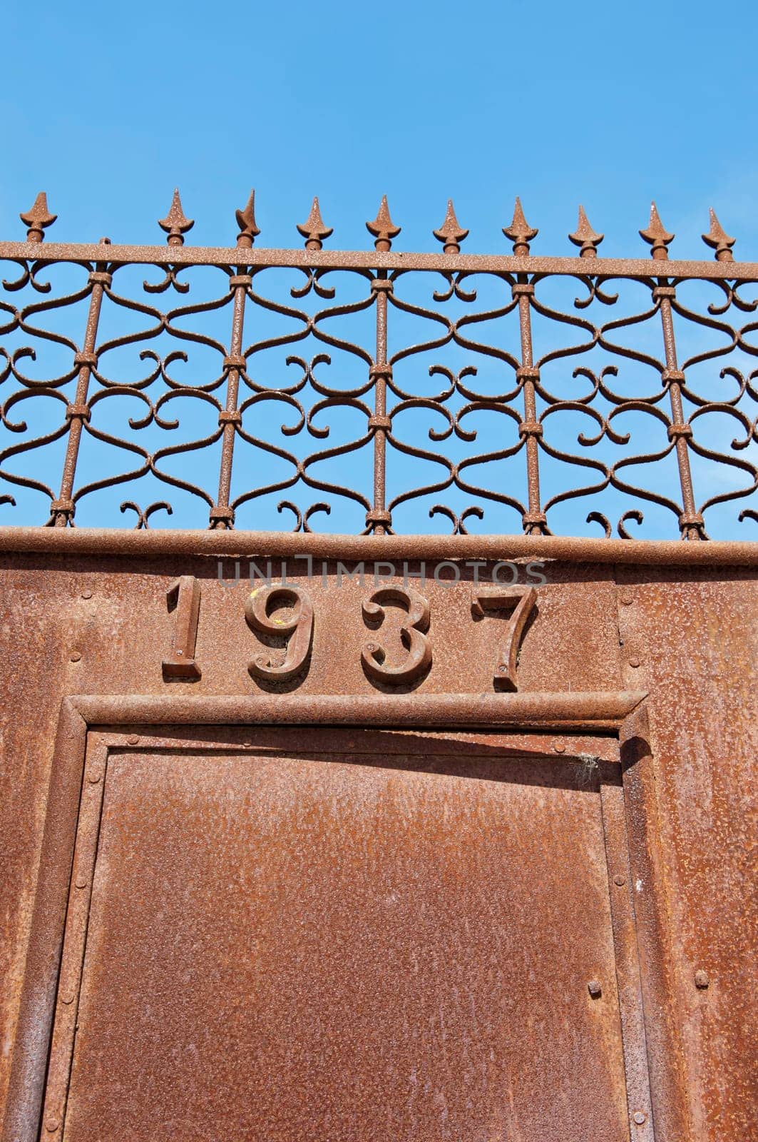 Rusty iron gate, dated 1937, in Portugal