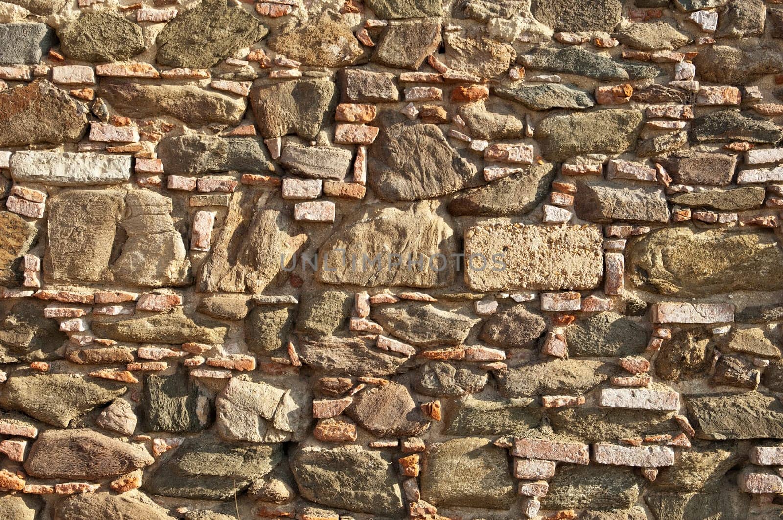 Old stone wall with some bricks in Portugal