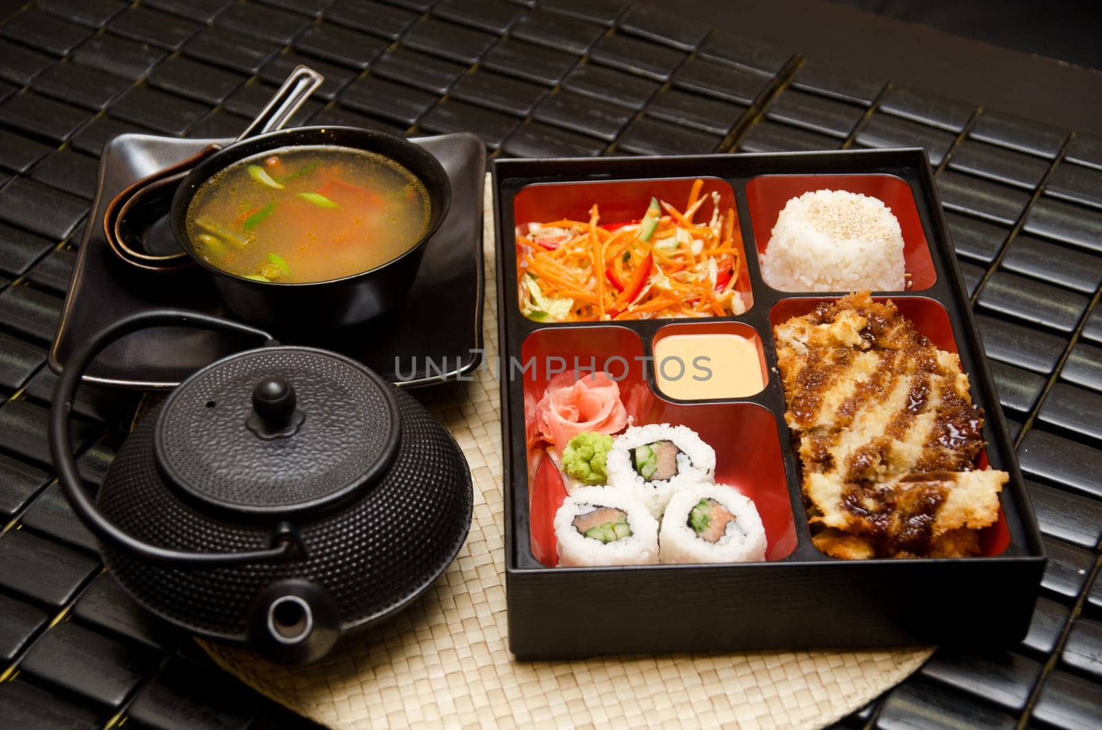 Sushi lunch with soup salad tea and sauce