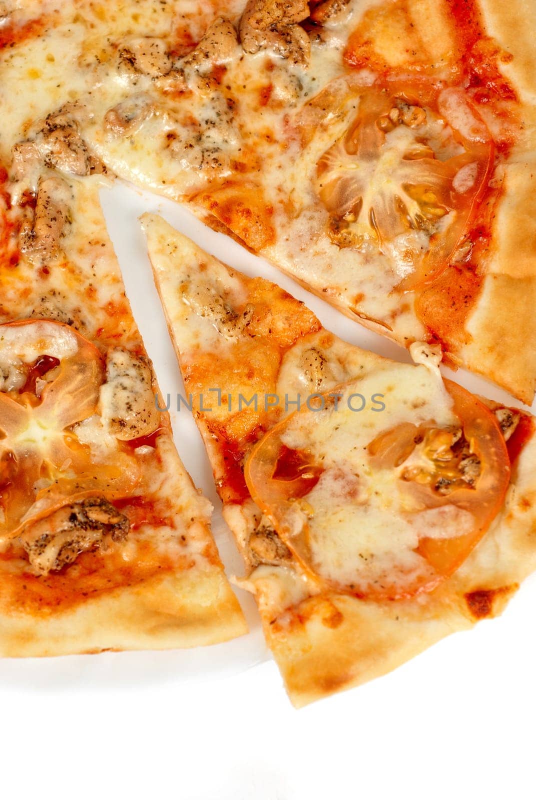 pizza closeup with chicken fillet, tomato and mozzarella cheese