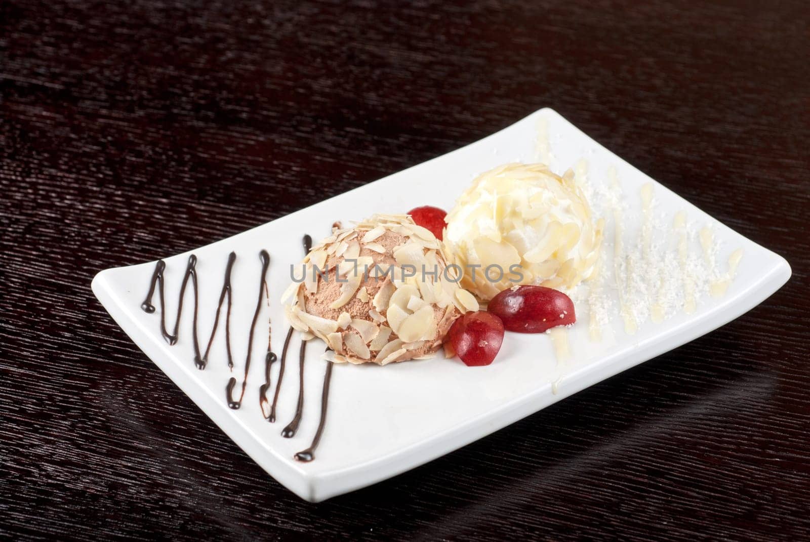 Dessert set of ice-cream with almond, chocolate and grapes
