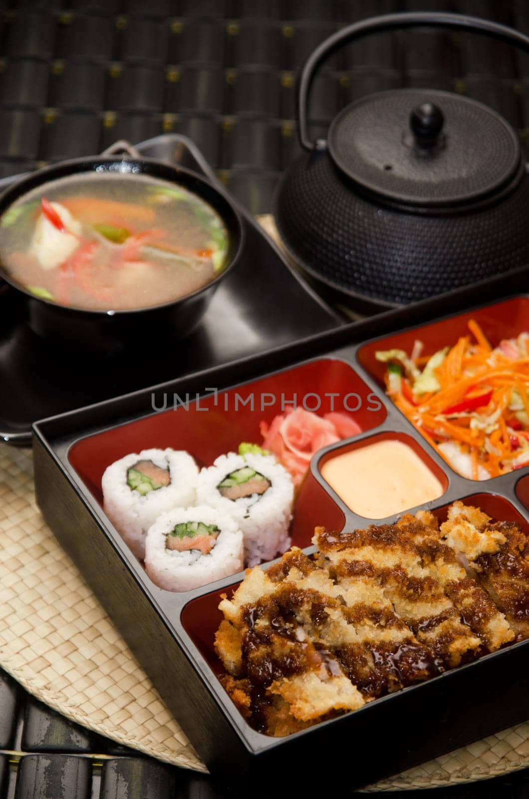 Sushi lunch with soup salad tea and sauce