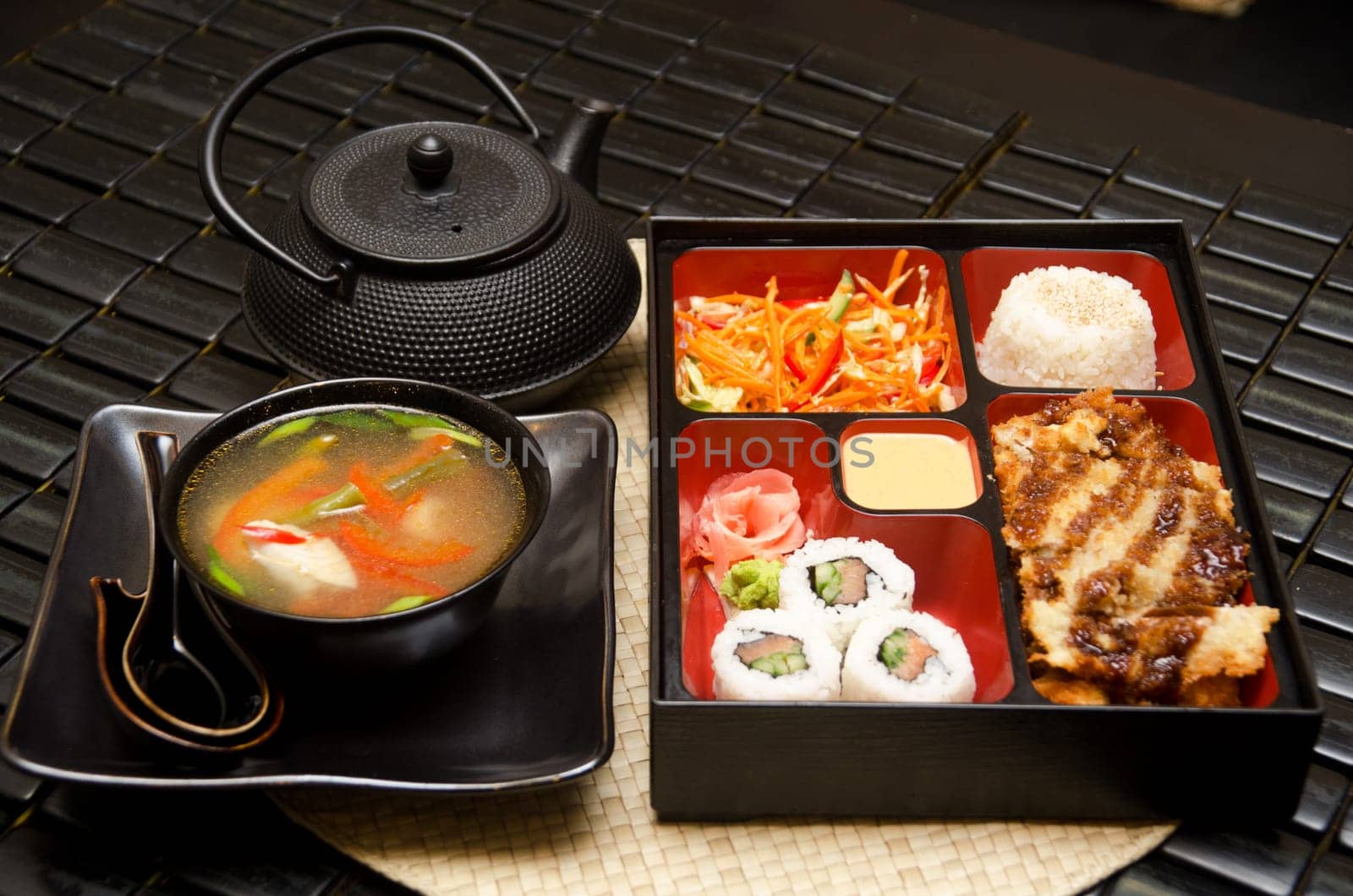 Sushi lunch with soup salad tea and sauce