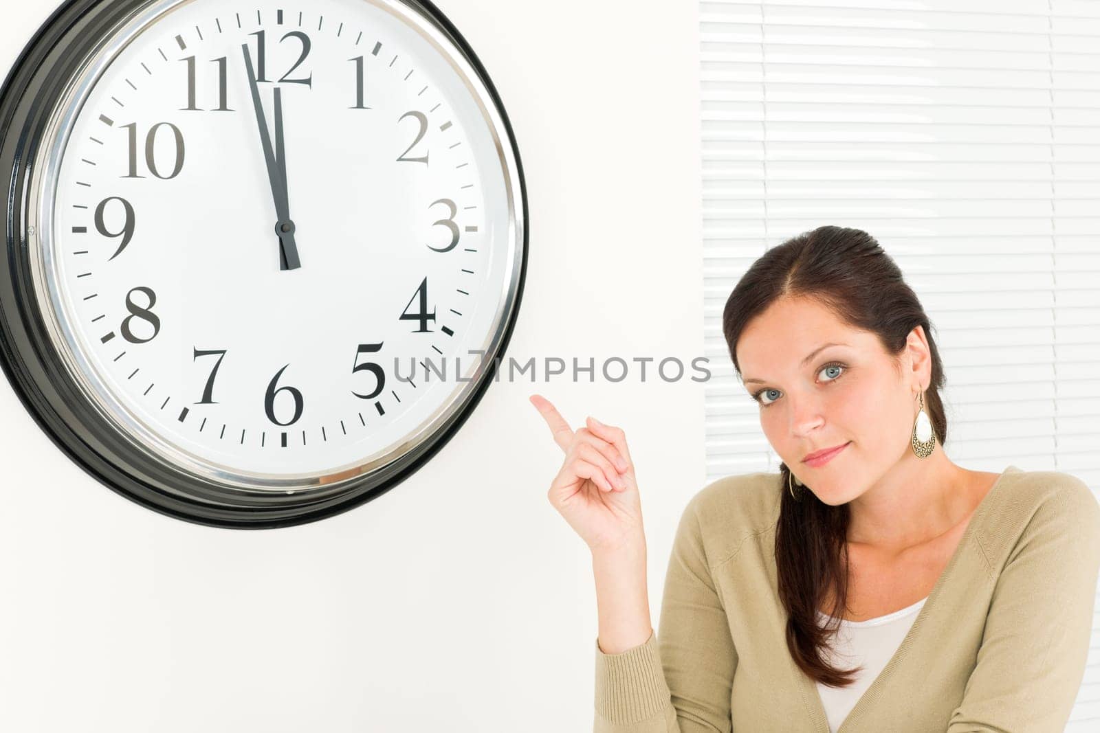 Punctual businesswoman young attractive pointing at clock portrait