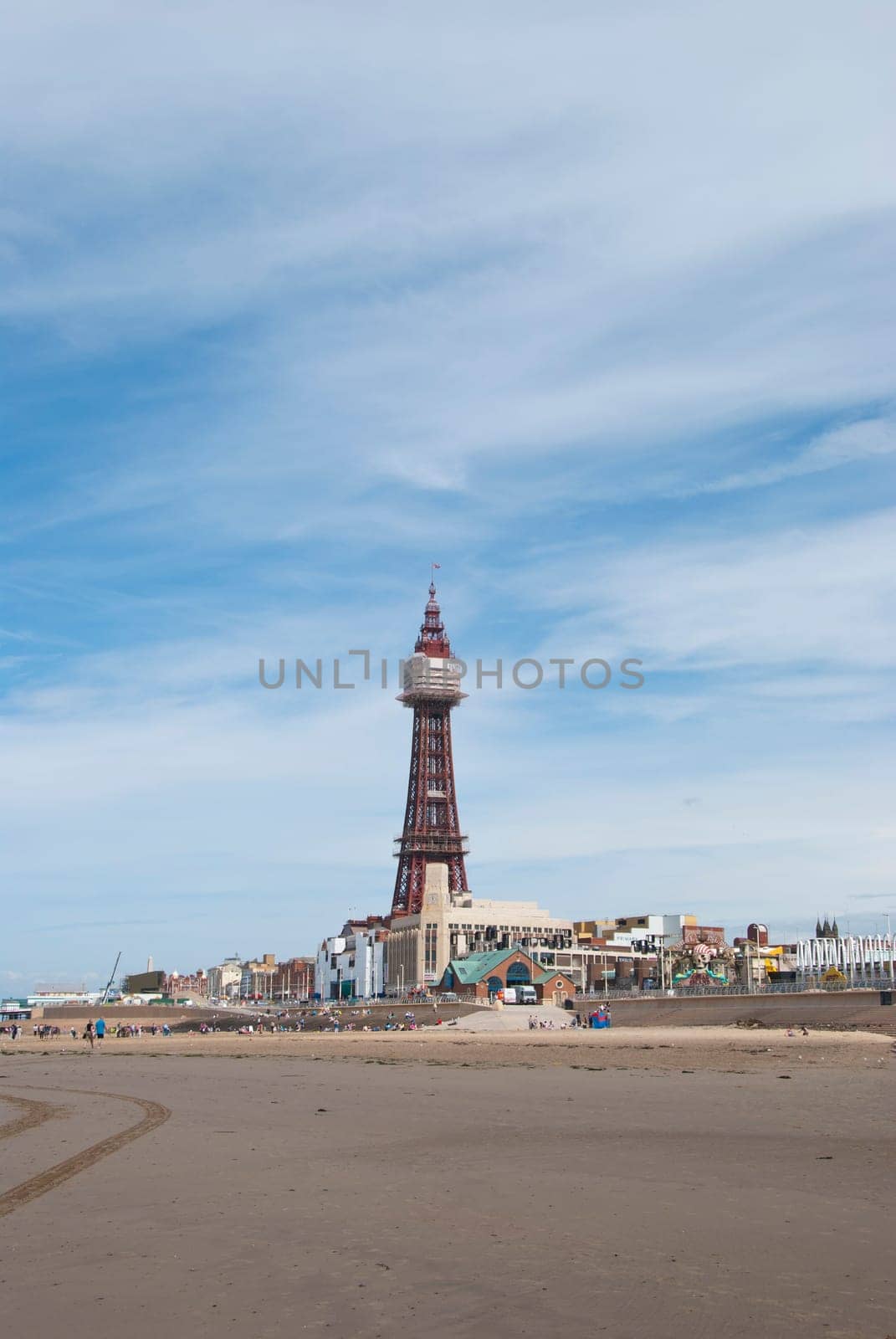The Famous Tower of Blackpool taken from the beach under a blue sky