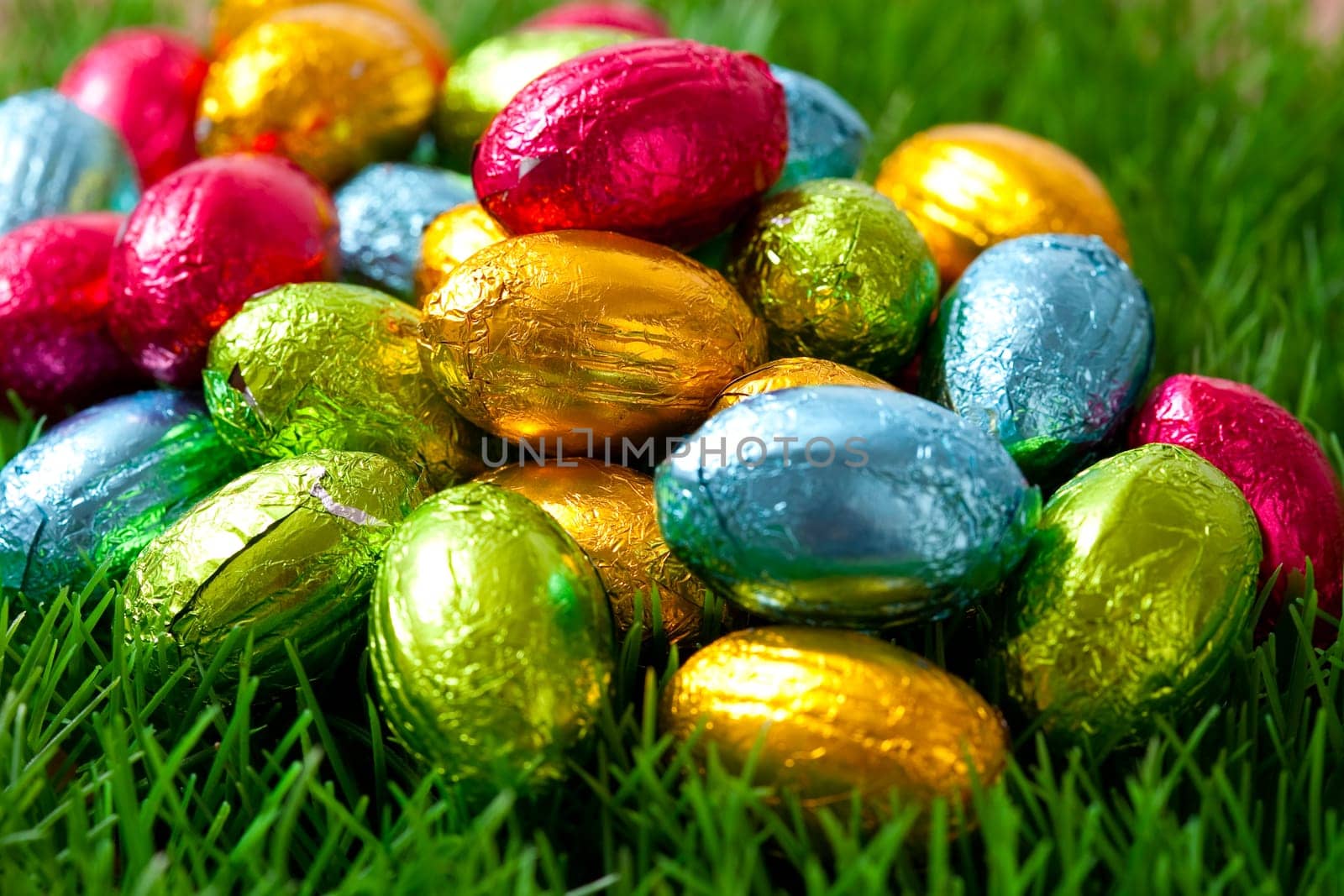 Close-up on chocolate Easter eggs on grass.