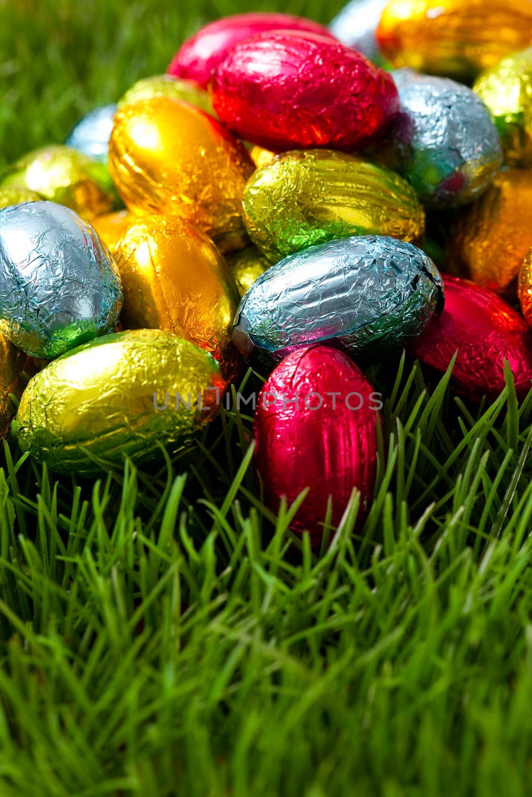 Close-up on chocolate Easter eggs on grass.