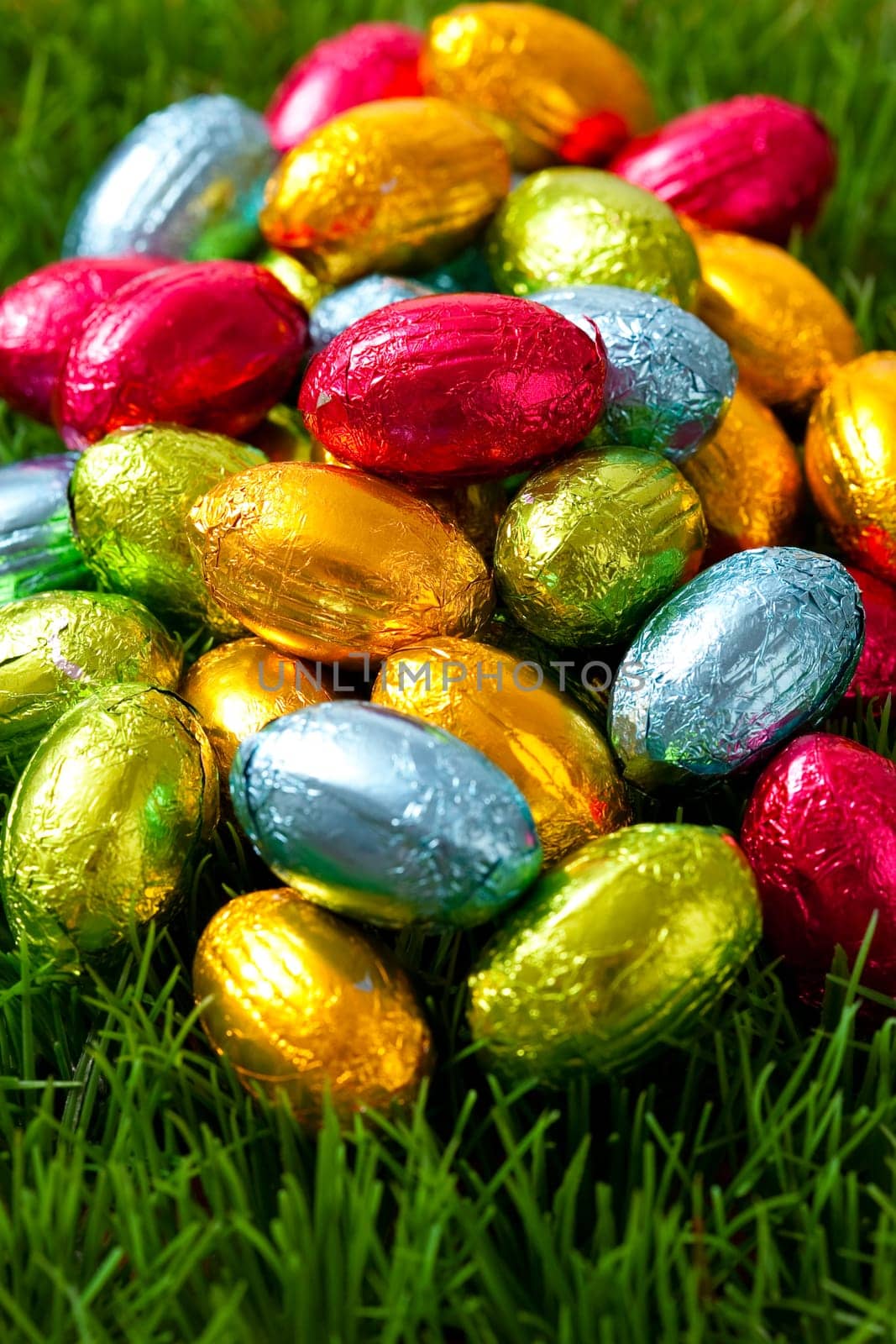 Close-up on chocolate Easter eggs on grass.