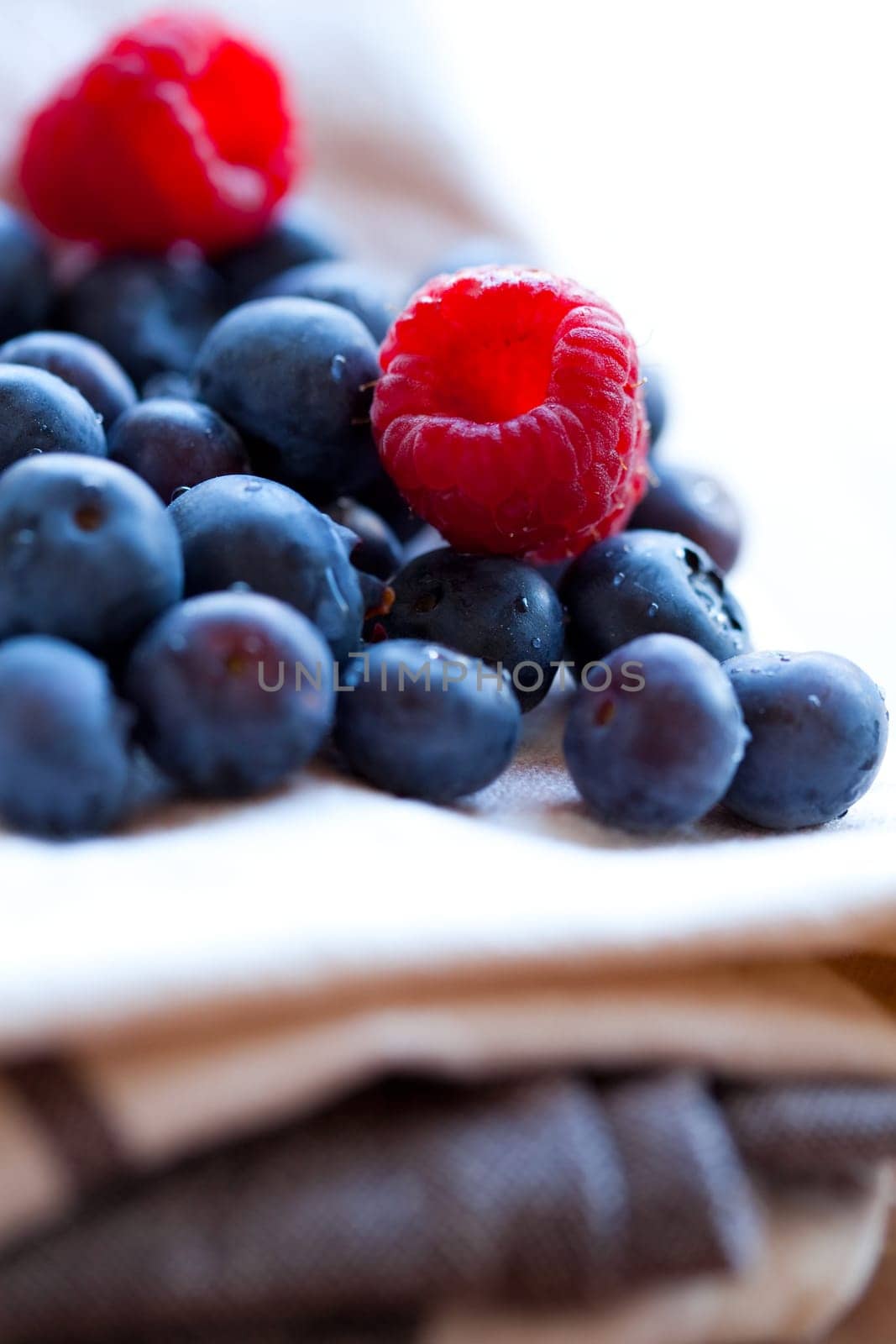 Close-up of delicious fresh blueberries and raspberries. Studio shot.