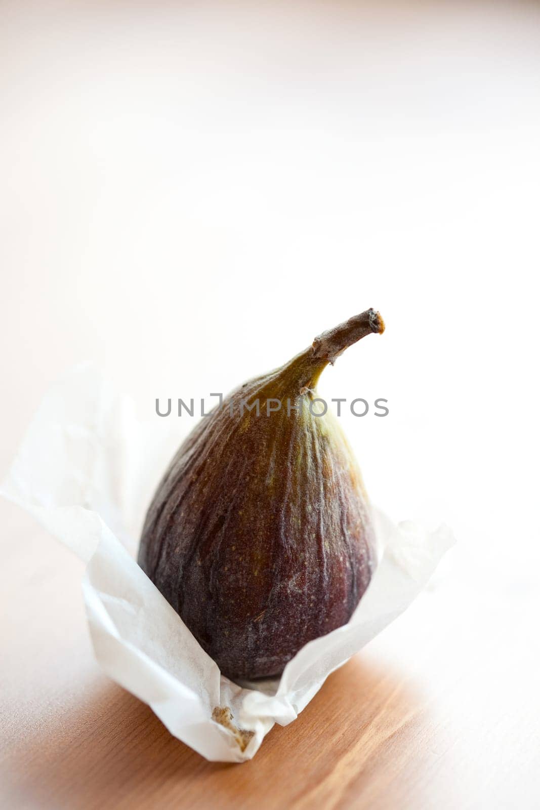 Delicious fresh fig on a wooden table. Studio shot.