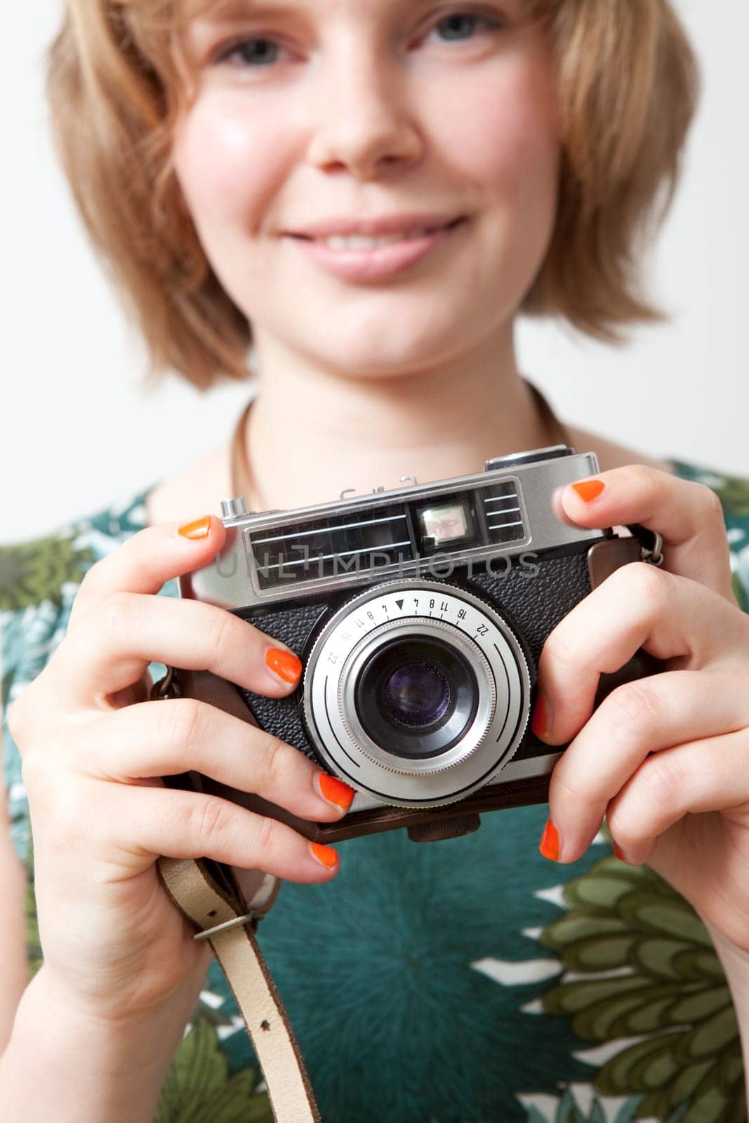 Young woman holding an old vintage camera