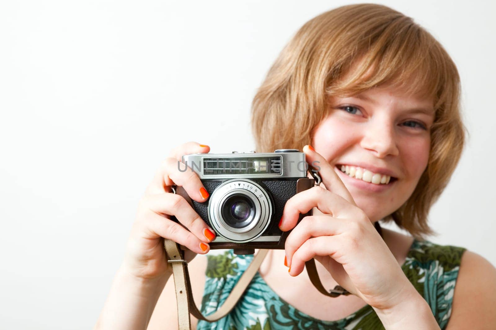 Young woman holding an old vintage camera