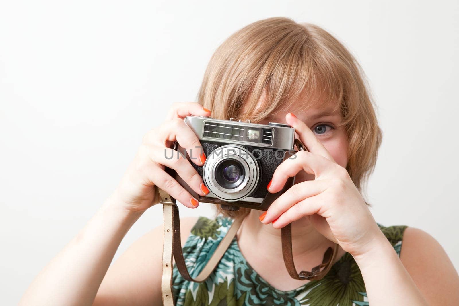 Young woman holding an old vintage camera