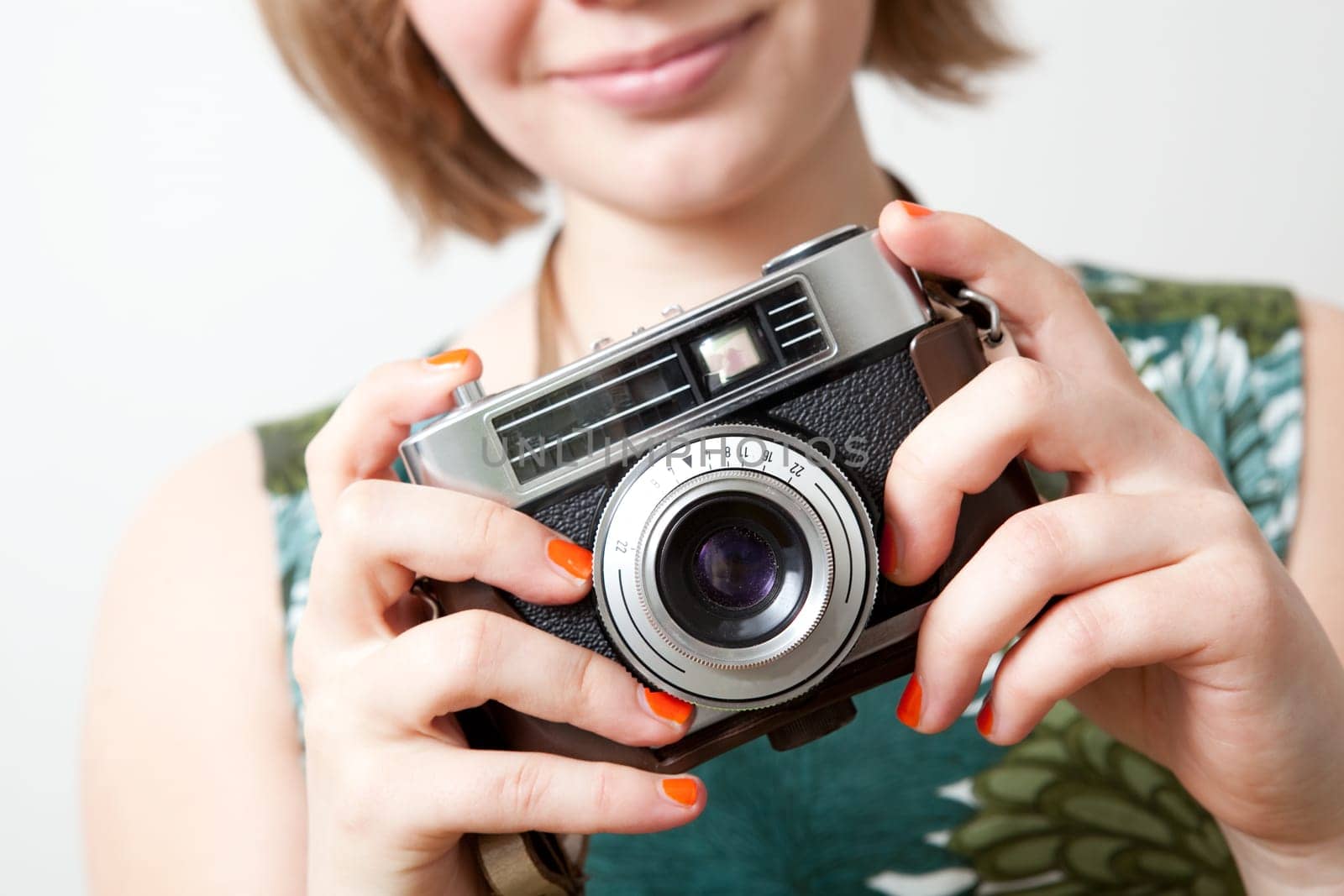 Young woman holding an old vintage camera