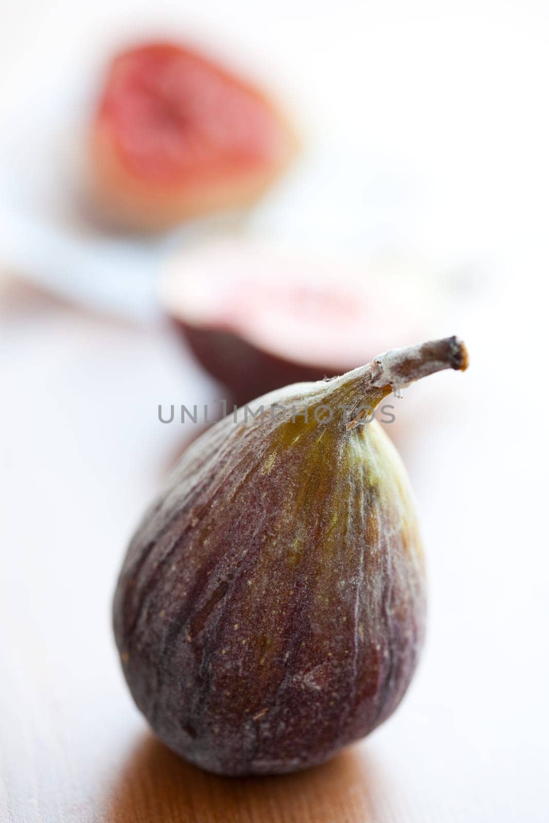 Delicious fresh figs on a wooden table. Studio shot.