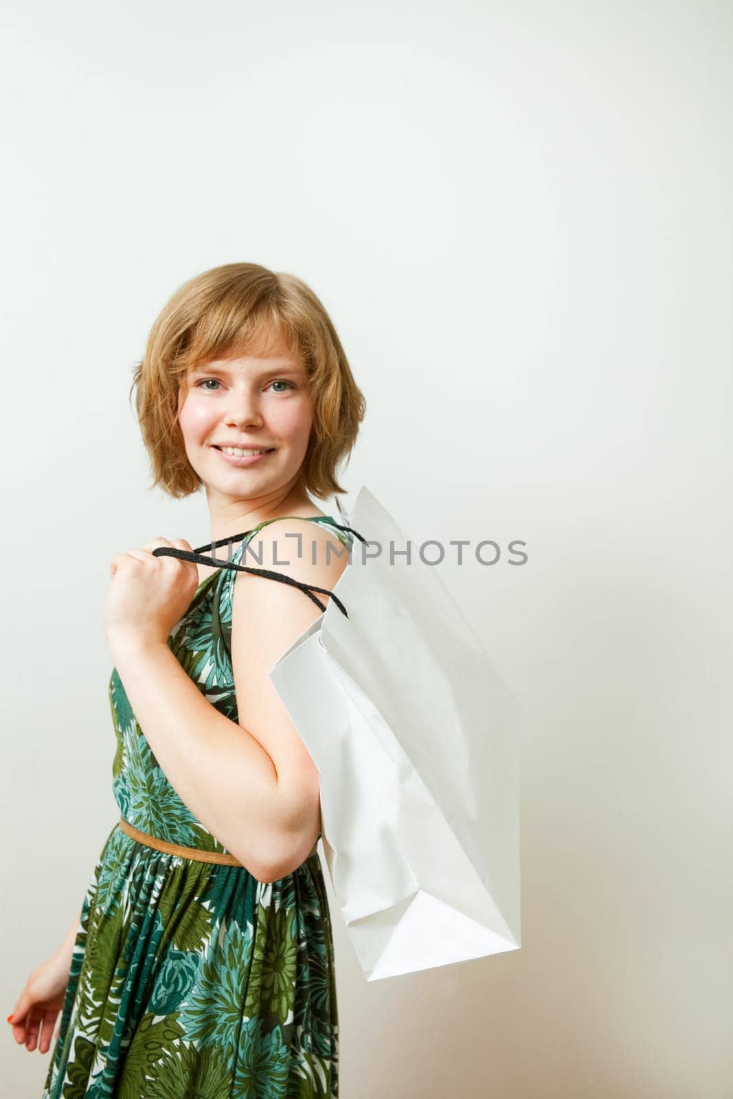 Young woman carrying a shopping bag on her shoulder